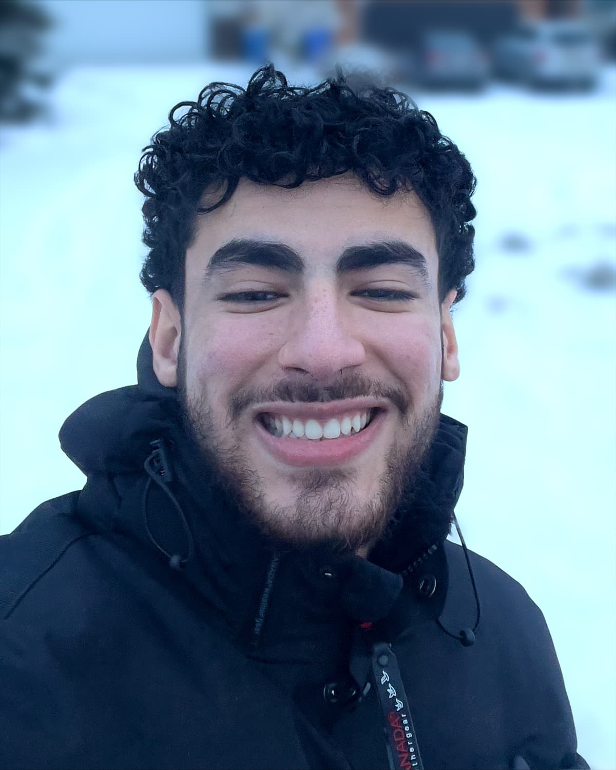 Abdelrahman Mohamed smiling outdoors in the snow